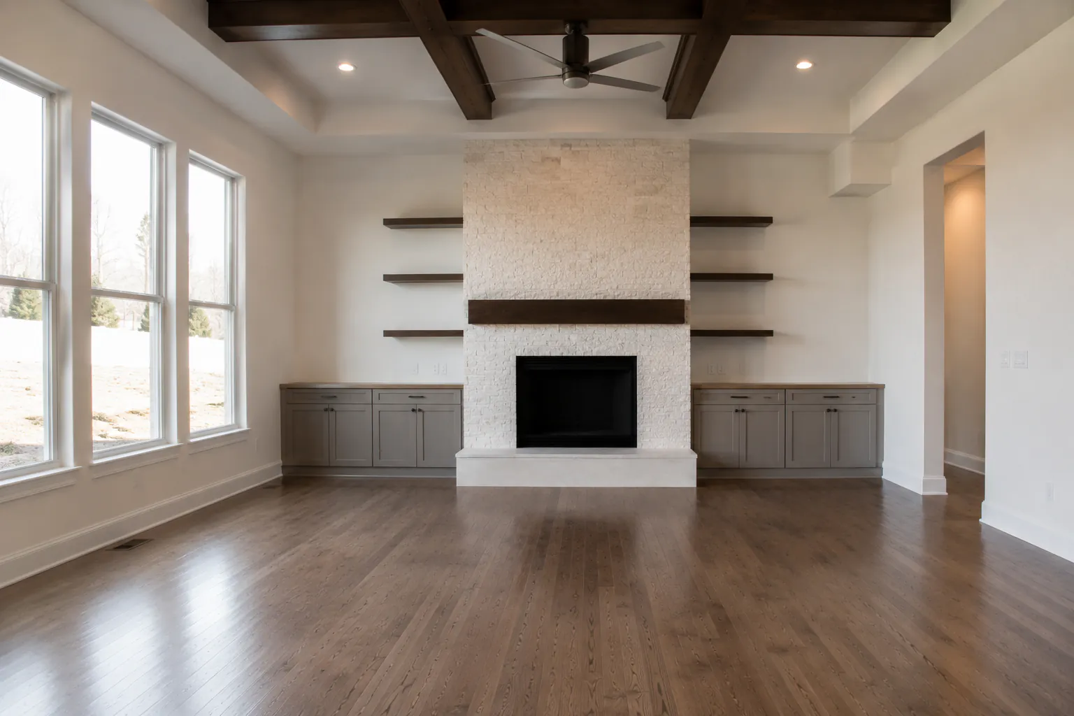 Empty, unfurnished room with bare floors and walls
