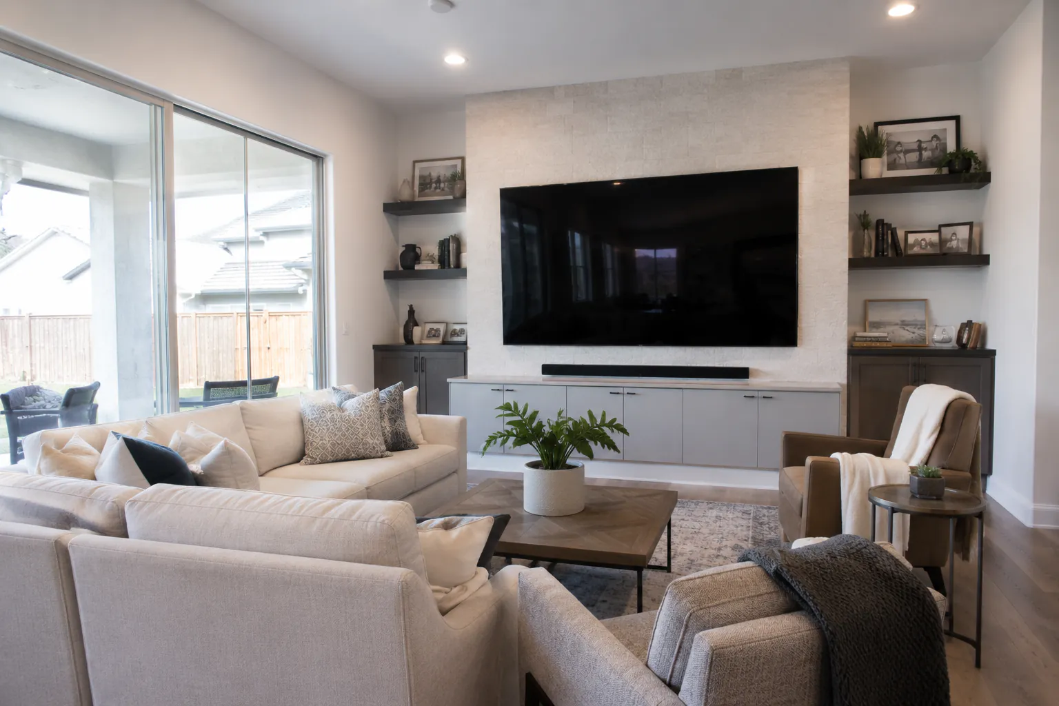 Living room with a black, powered-off TV screen on the wall